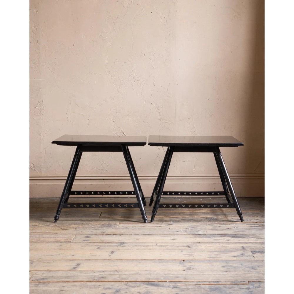 A matched pair of square ebonised wooden side tables with splayed turned legs and decorative pierced lower stretchers. View VI