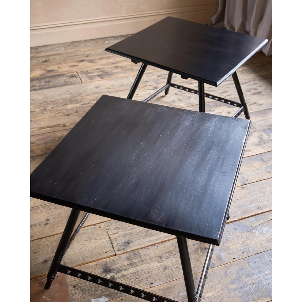 A matched pair of square ebonised wooden side tables with splayed turned legs and decorative pierced lower stretchers. View VIII