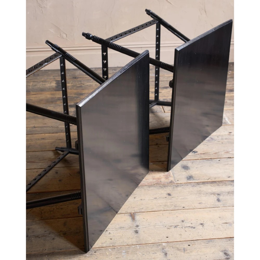 A matched pair of square ebonised wooden side tables with splayed turned legs and decorative pierced lower stretchers. View IX