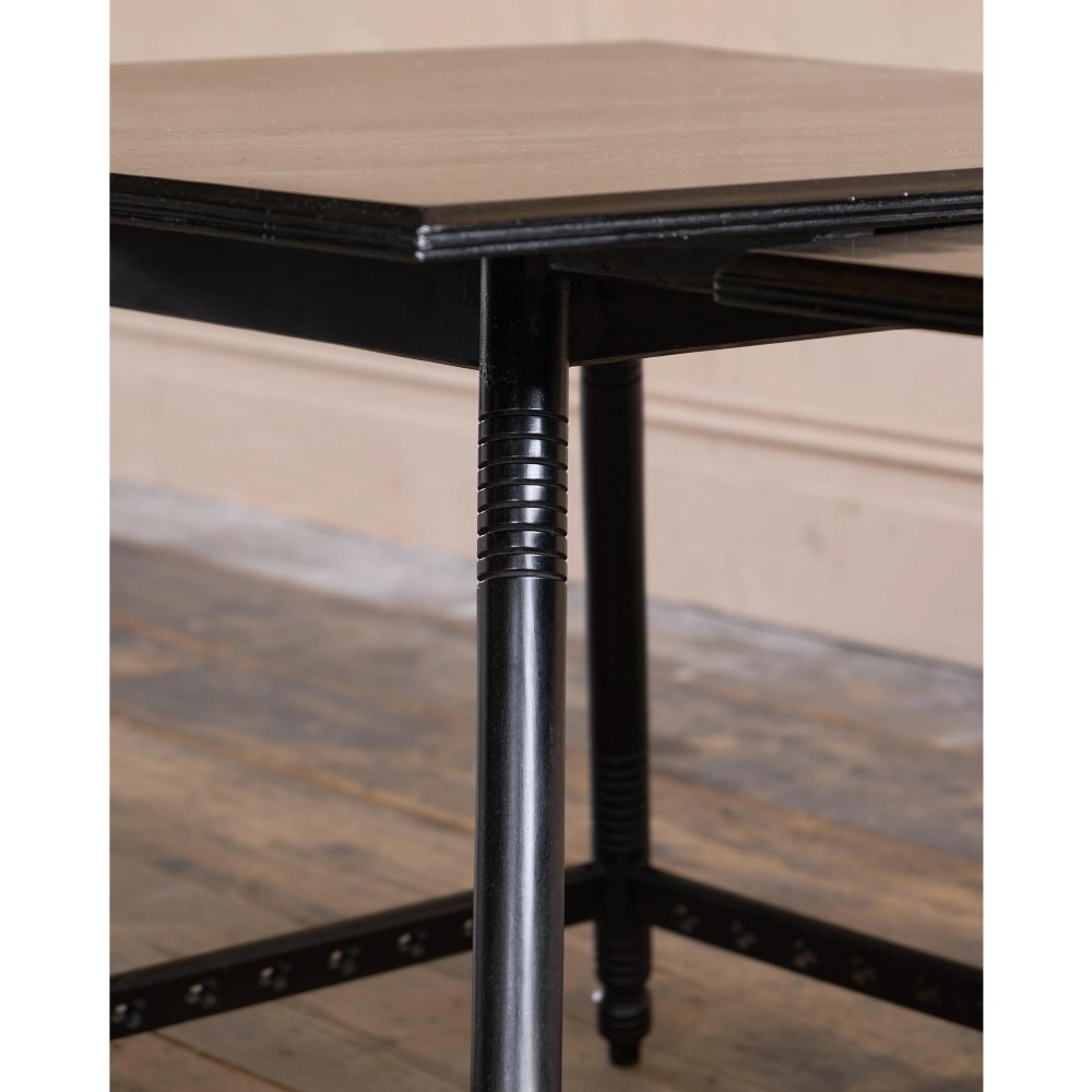 A matched pair of square ebonised wooden side tables with splayed turned legs and decorative pierced lower stretchers. View XI