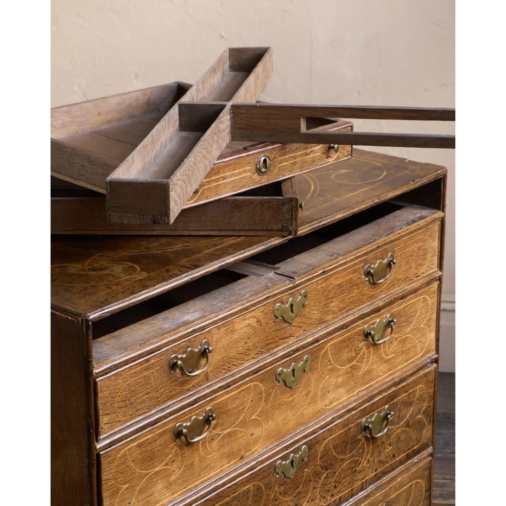 A late 17th-century William and Mary oak chest of drawers featuring geometric scrollwork inlay and brass drop handles. View XIII