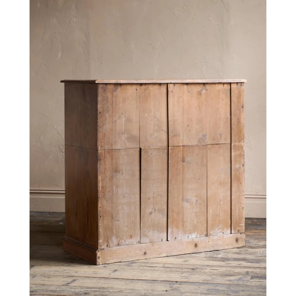 A Victorian pitch pine chest of drawers featuring two short over three long drawers framed with carved faux bamboo mouldings and turned wooden knobs. View VI