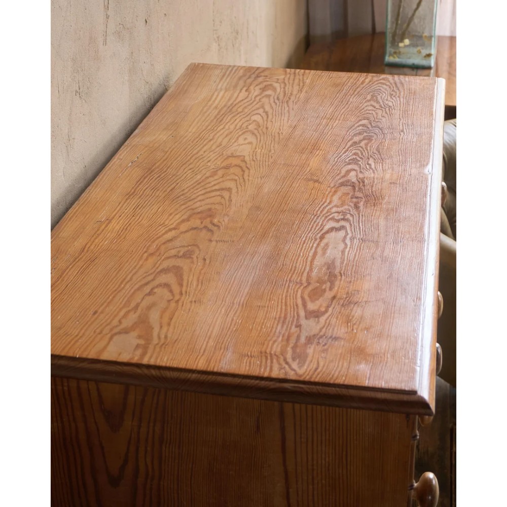 A Victorian pitch pine chest of drawers featuring two short over three long drawers framed with carved faux bamboo mouldings and turned wooden knobs. View XIII