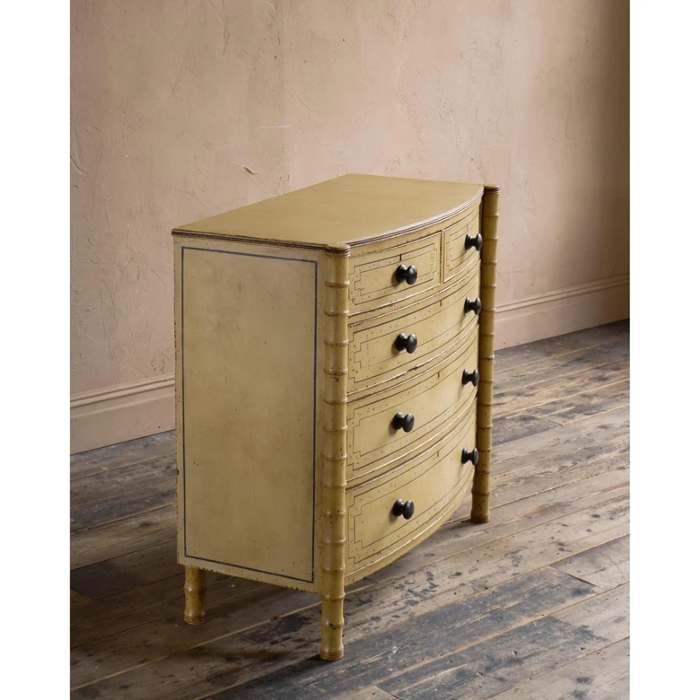 A Regency pale yellow painted chest of drawers featuring simulated bamboo turned corner columns and dark turned knobs. View III