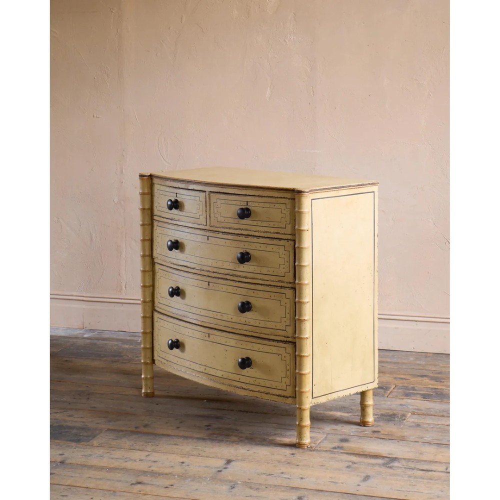 A Regency pale yellow painted chest of drawers featuring simulated bamboo turned corner columns and dark turned knobs. View IV