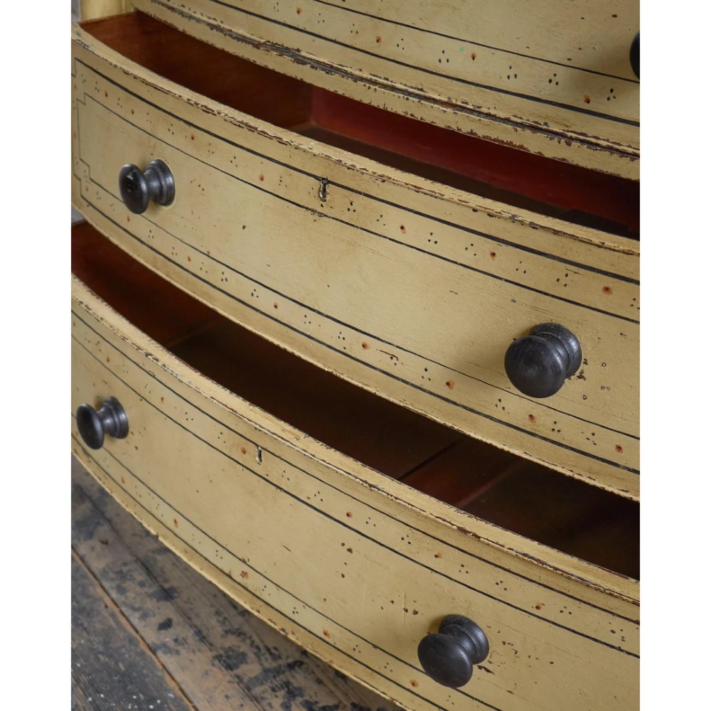 A Regency pale yellow painted chest of drawers featuring simulated bamboo turned corner columns and dark turned knobs. View XII