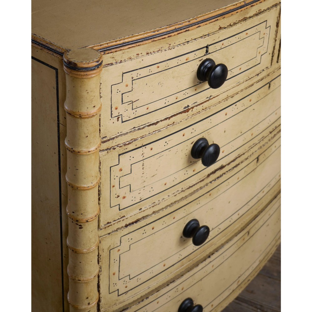 A Regency pale yellow painted chest of drawers featuring simulated bamboo turned corner columns and dark turned knobs. View XIII