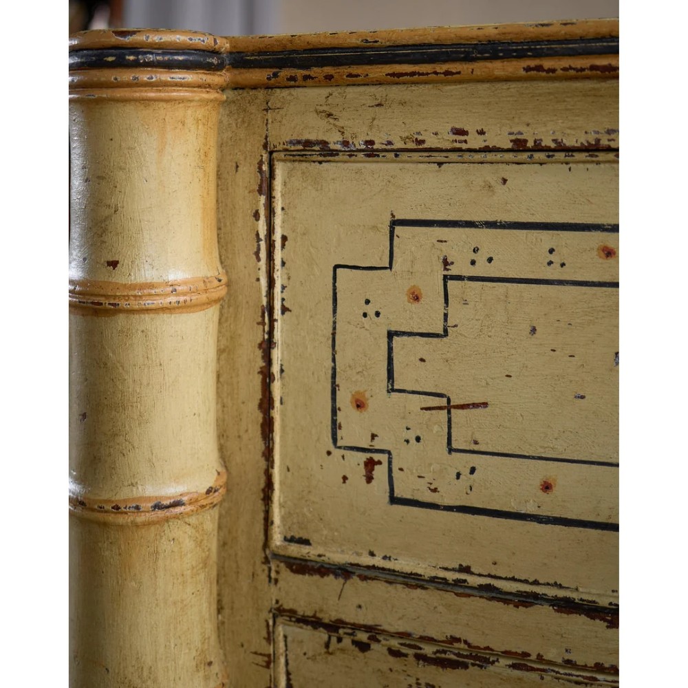 A Regency pale yellow painted chest of drawers featuring simulated bamboo turned corner columns and dark turned knobs. View XIV