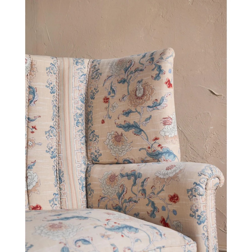 A nineteenth-century fluted wingback sofa featuring patterned floral upholstery, vertical channel tufting, and turned timber legs with brass castors. View IX