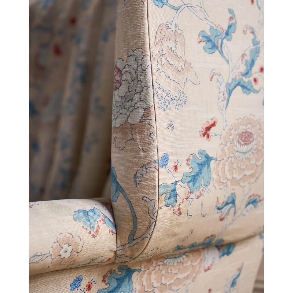 A nineteenth-century fluted wingback sofa featuring patterned floral upholstery, vertical channel tufting, and turned timber legs with brass castors. View XII
