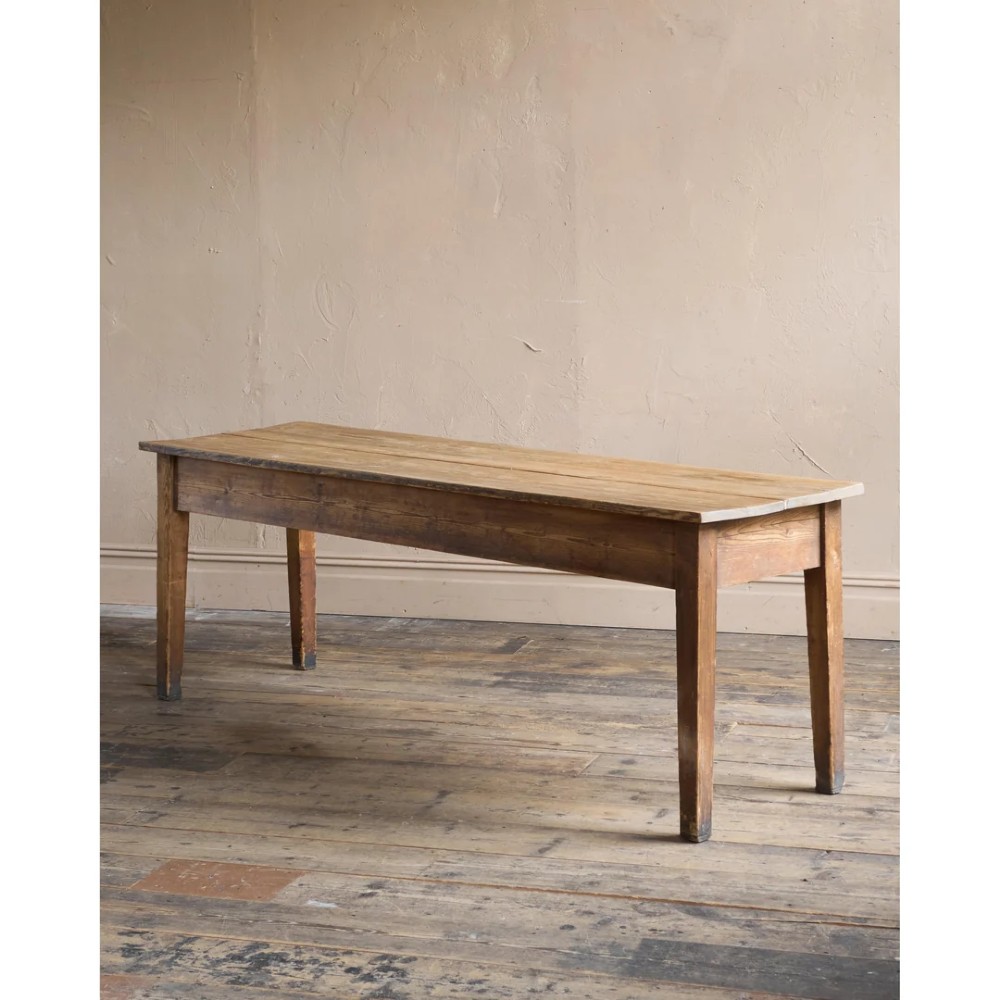 A long natural pine scullery table featuring three drawer fronts with dark wooden knobs and straight legs. View VII