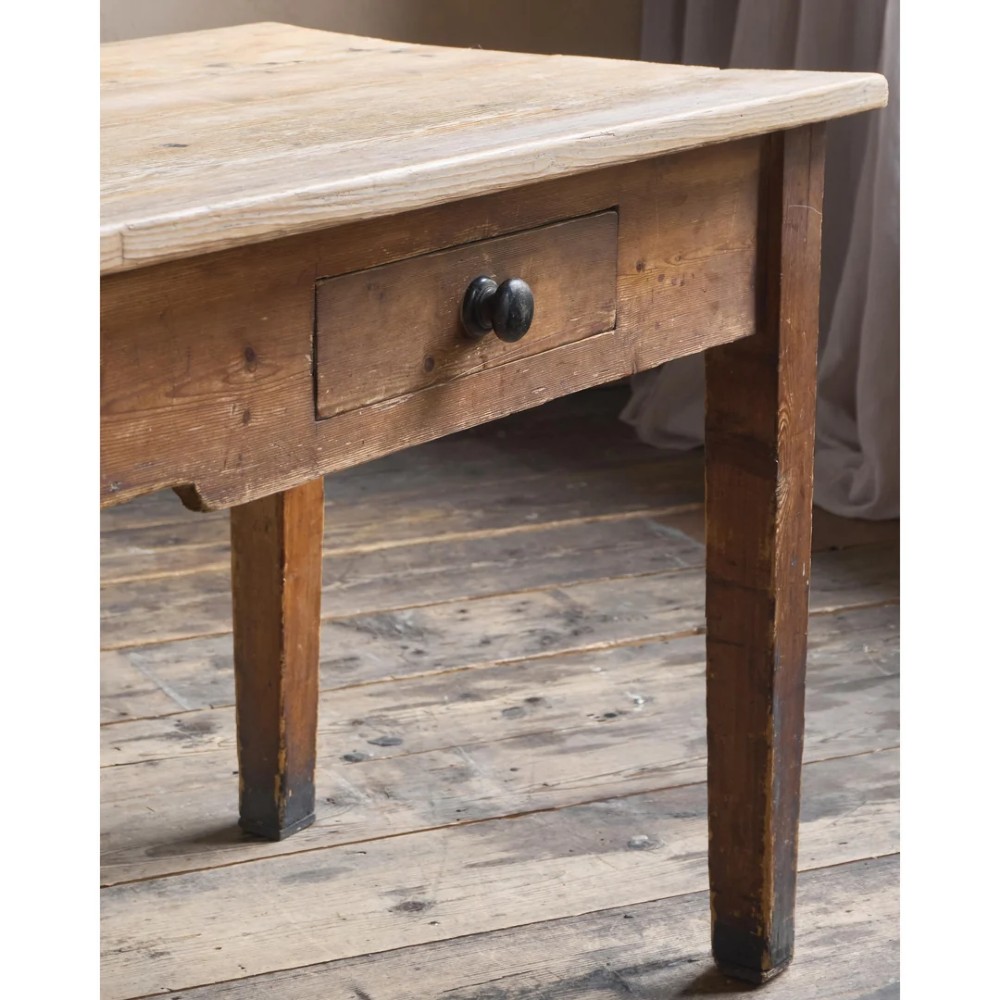 A long natural pine scullery table featuring three drawer fronts with dark wooden knobs and straight legs. View IX