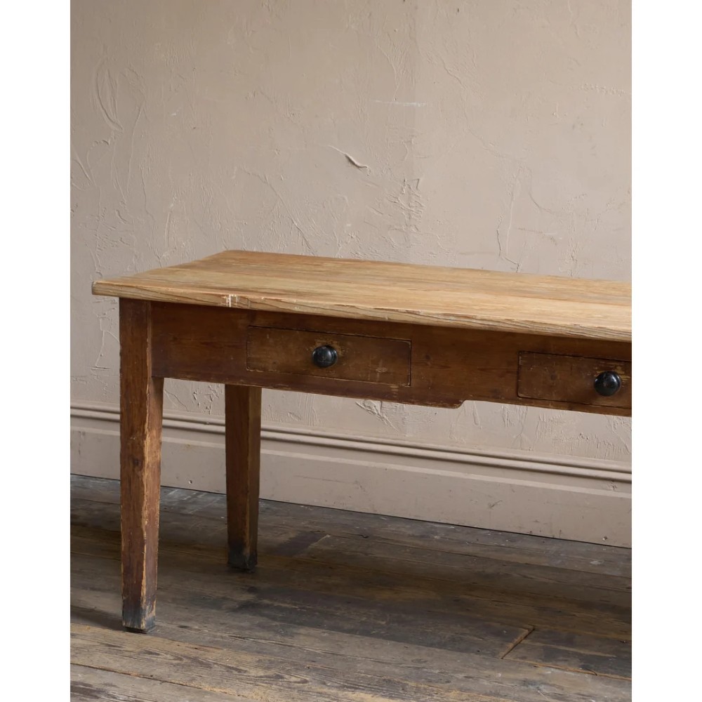 A long natural pine scullery table featuring three drawer fronts with dark wooden knobs and straight legs. View XI