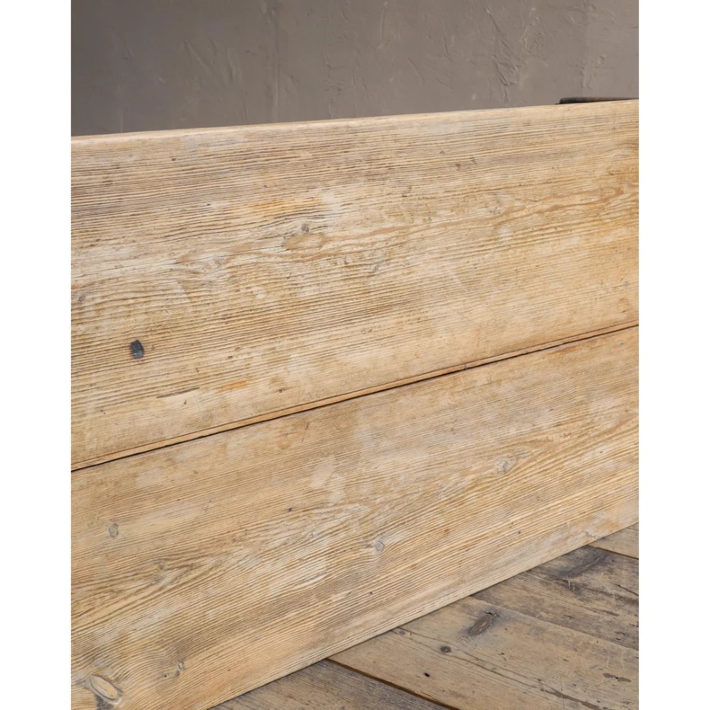 A long natural pine scullery table featuring three drawer fronts with dark wooden knobs and straight legs. View XIV