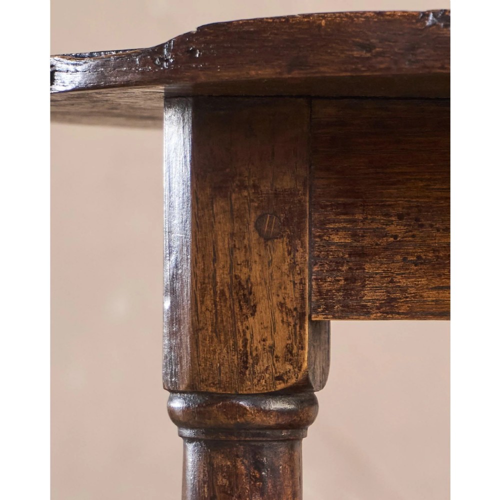 An 18th-century dark oak cricket table featuring a trefoil-shaped top, three turned legs, a triangular lower shelf, and a stretcher base. View IX