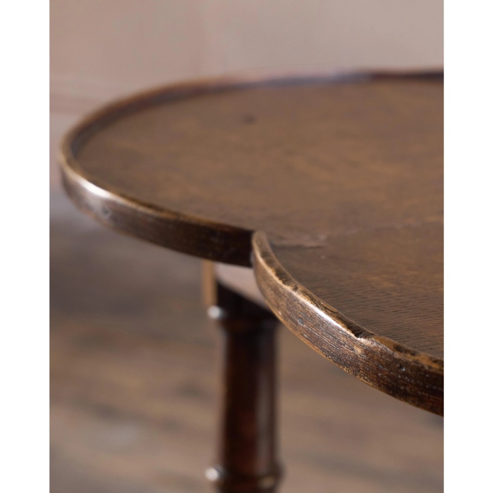 An 18th-century dark oak cricket table featuring a trefoil-shaped top, three turned legs, a triangular lower shelf, and a stretcher base. View XIV
