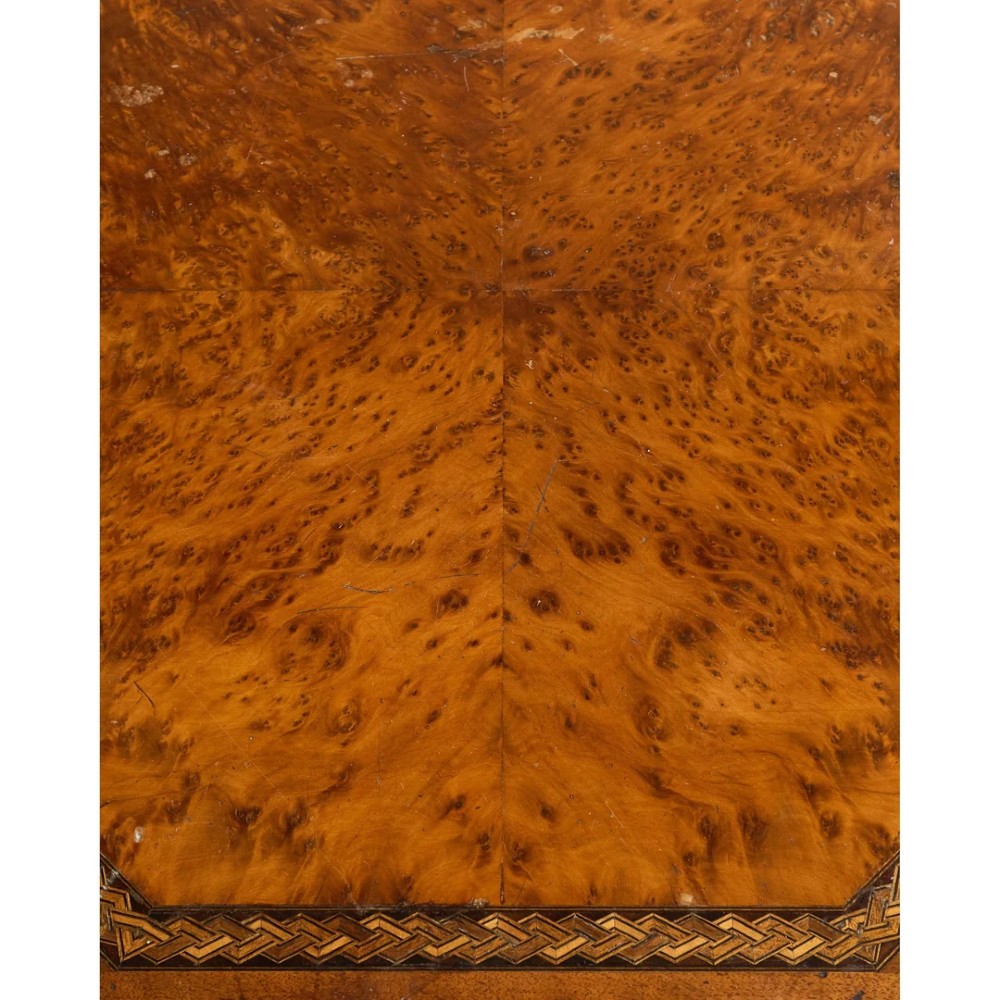 An octagonal Victorian side table featuring an amboyna wood veneer top with gilt borders, turned legs, a lower shelf with a spindle gallery, and brass castors. View XI