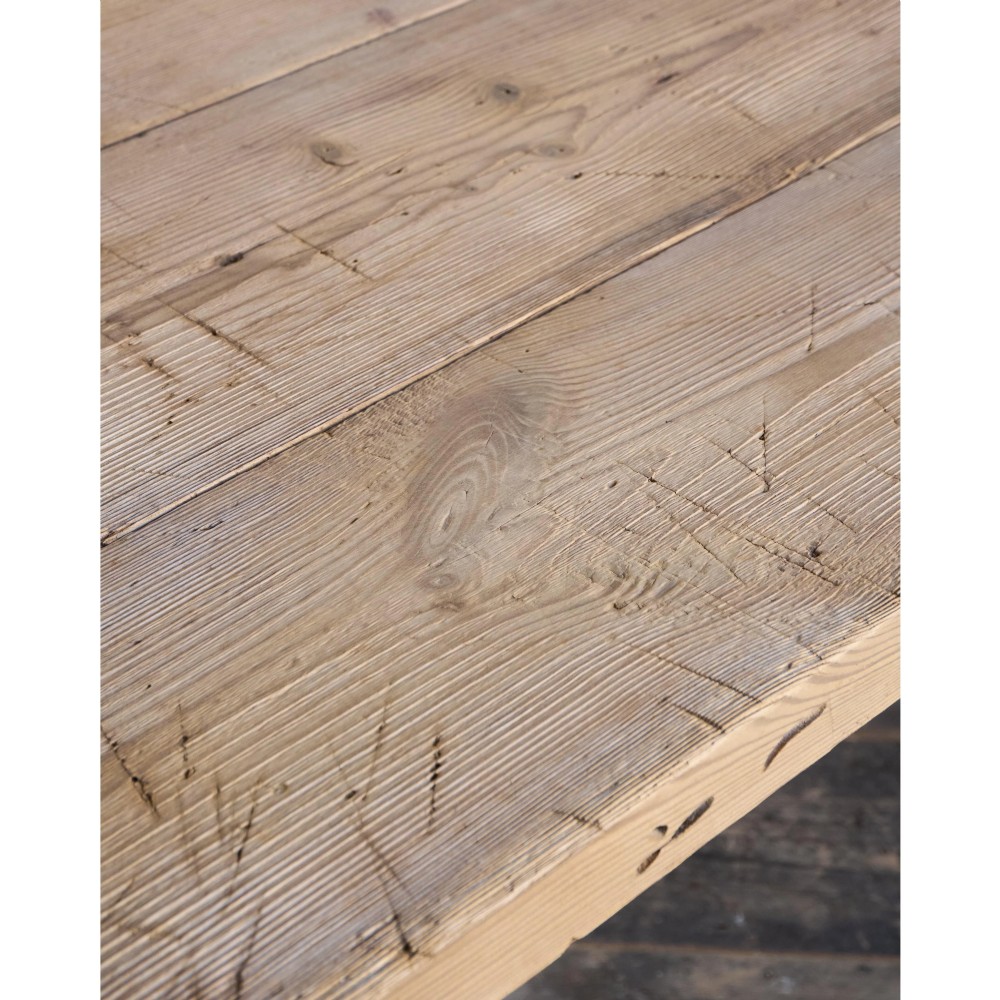 A primitive rustic dining table constructed from weathered pale timber with a rough-hewn plank top and diagonal cross-braced legs. View XIII