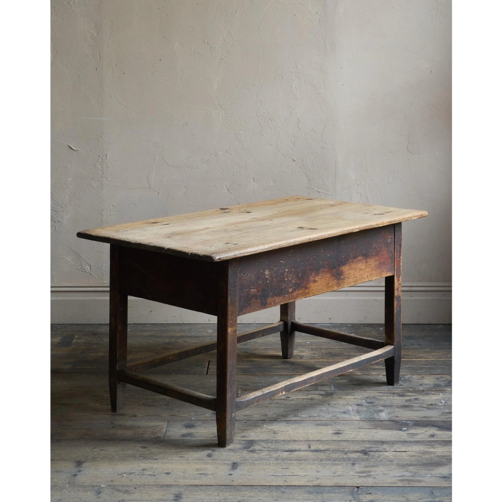 A rustic Swedish painted pine table featuring a scrubbed rectangular top, single frieze drawer, and dark painted base with box stretchers. View II
