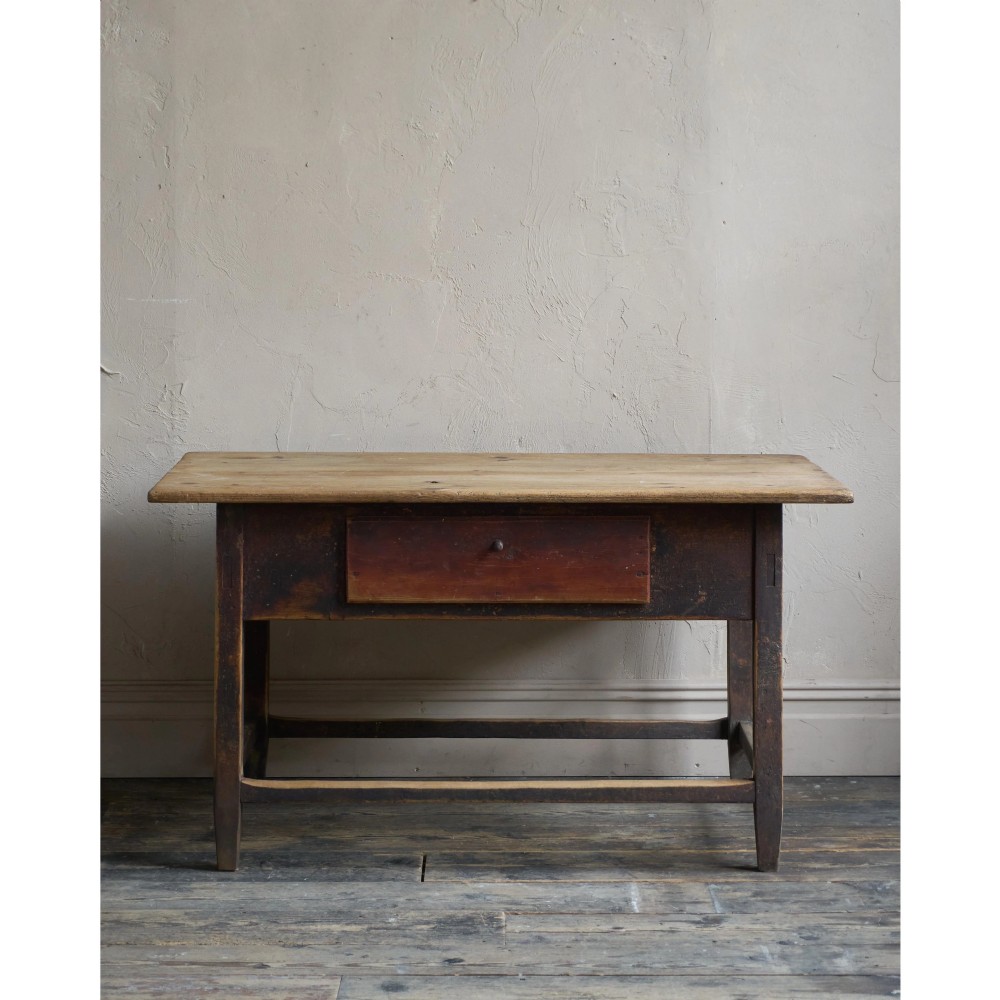 A rustic Swedish painted pine table featuring a scrubbed rectangular top, single frieze drawer, and dark painted base with box stretchers. View III