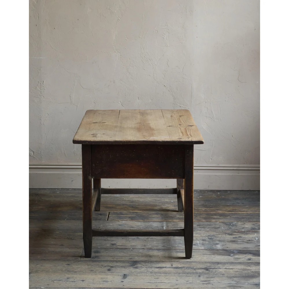A rustic Swedish painted pine table featuring a scrubbed rectangular top, single frieze drawer, and dark painted base with box stretchers. View IV
