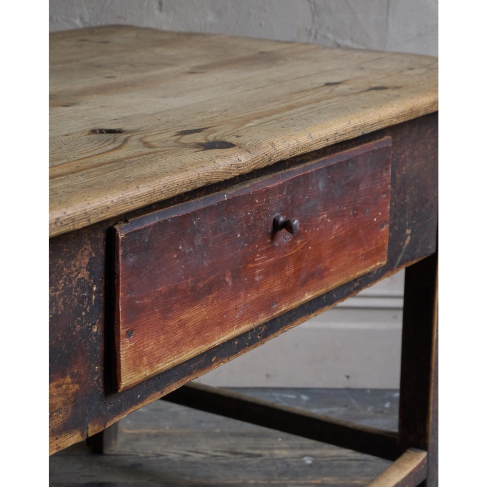A rustic Swedish painted pine table featuring a scrubbed rectangular top, single frieze drawer, and dark painted base with box stretchers. View VII