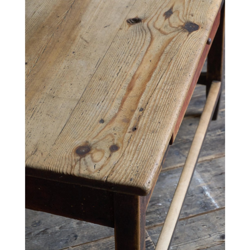 A rustic Swedish painted pine table featuring a scrubbed rectangular top, single frieze drawer, and dark painted base with box stretchers. View X