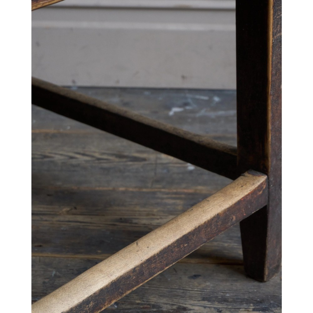A rustic Swedish painted pine table featuring a scrubbed rectangular top, single frieze drawer, and dark painted base with box stretchers. View XI