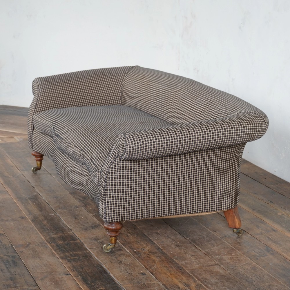 A Victorian Chesterfield sofa featuring deep-buttoned floral pattern upholstery, rolled arms, and turned wooden legs fitted with brass castors. View XIII