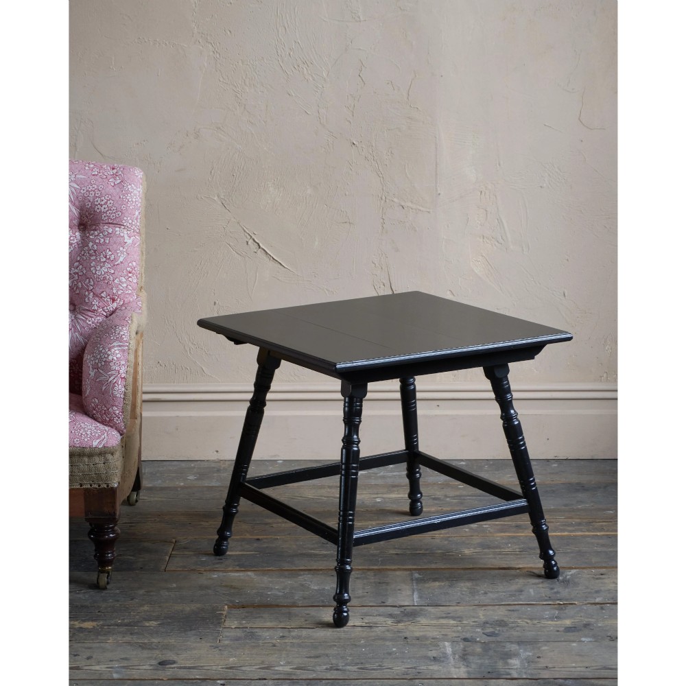 A square ebonised wood side table featuring slender turned legs connected by a lower square stretcher frame. View III