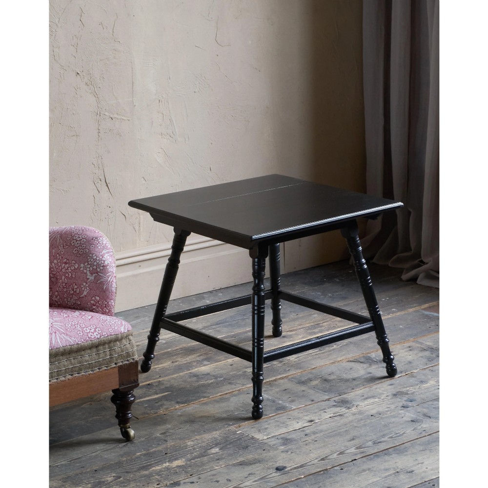 A square ebonised wood side table featuring slender turned legs connected by a lower square stretcher frame. View V