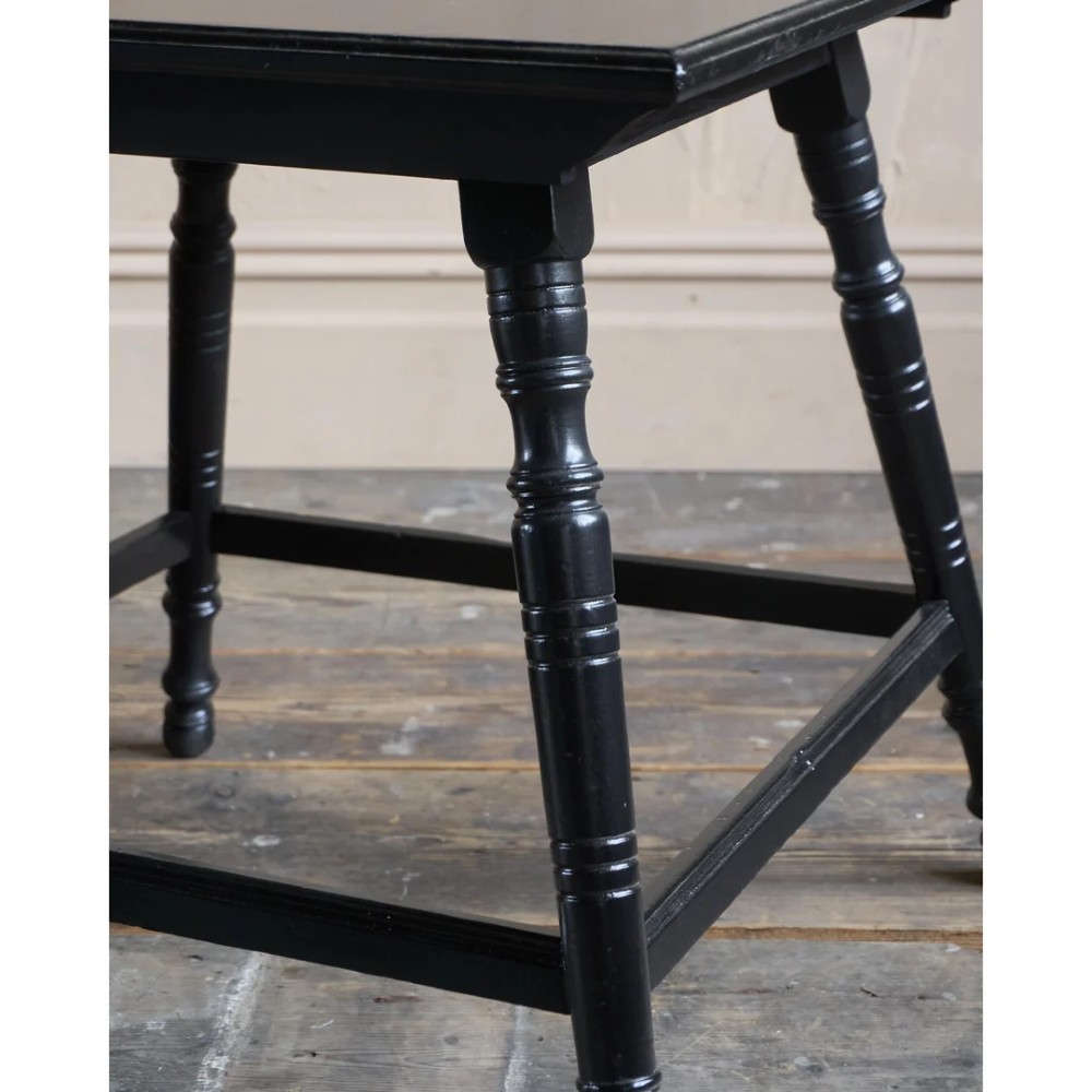 A square ebonised wood side table featuring slender turned legs connected by a lower square stretcher frame. View VII