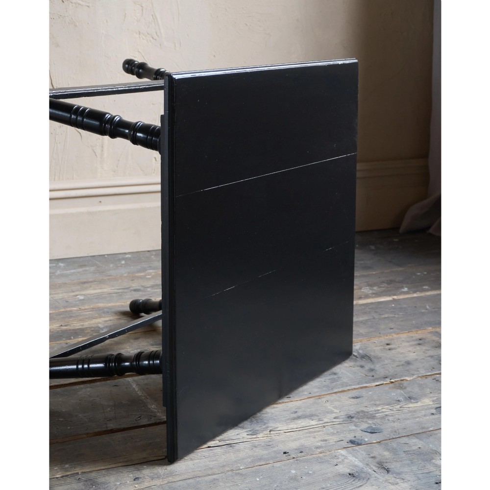 A square ebonised wood side table featuring slender turned legs connected by a lower square stretcher frame. View VIII