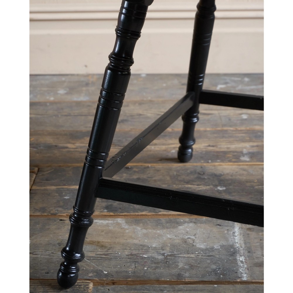 A square ebonised wood side table featuring slender turned legs connected by a lower square stretcher frame. View IX