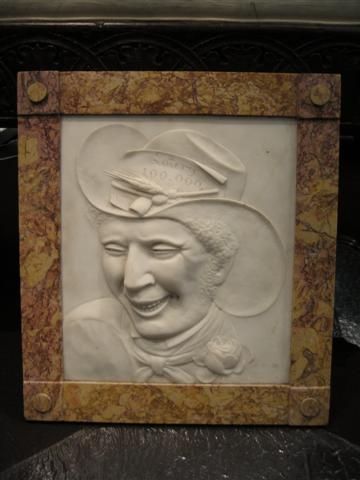fig 1. A pair of square carved white marble relief plaques depicting portrait busts set within ochre marble frames.