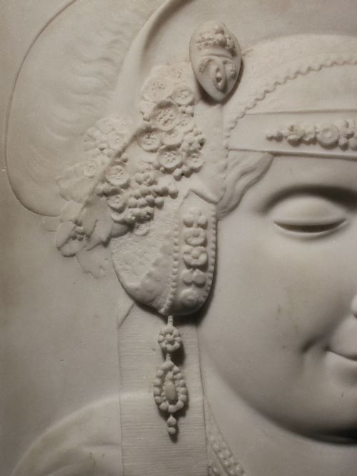 fig 3. A pair of square carved white marble relief plaques depicting portrait busts set within ochre marble frames.