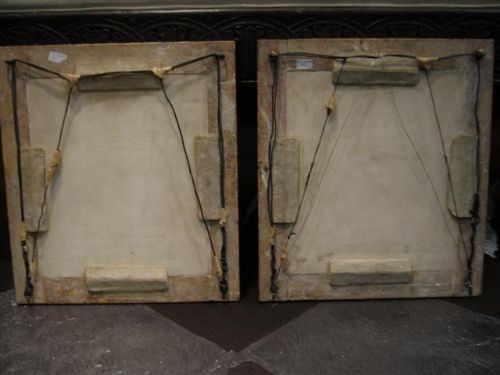 fig 5. A pair of square carved white marble relief plaques depicting portrait busts set within ochre marble frames.