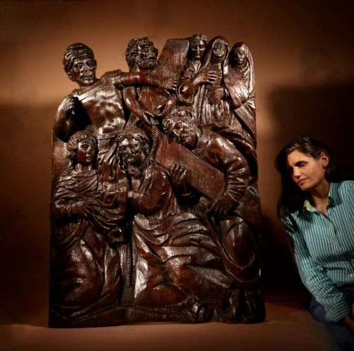fig 1. A 16th-century carved dark oak relief panel depicting Christ carrying the cross surrounded by biblical figures.