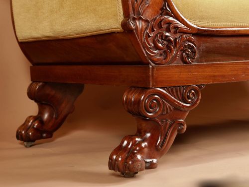 fig 1. A pair of carved mahogany settees upholstered in mustard yellow velvet with cylindrical bolster cushions.