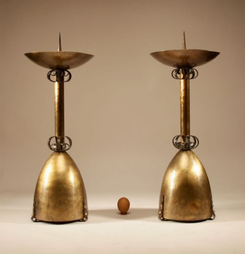 fig 1. A pair of tall hand-hammered brass pricket candlesticks featuring domed bases, decorative wrought iron collars, and wide top dishes with central spikes.