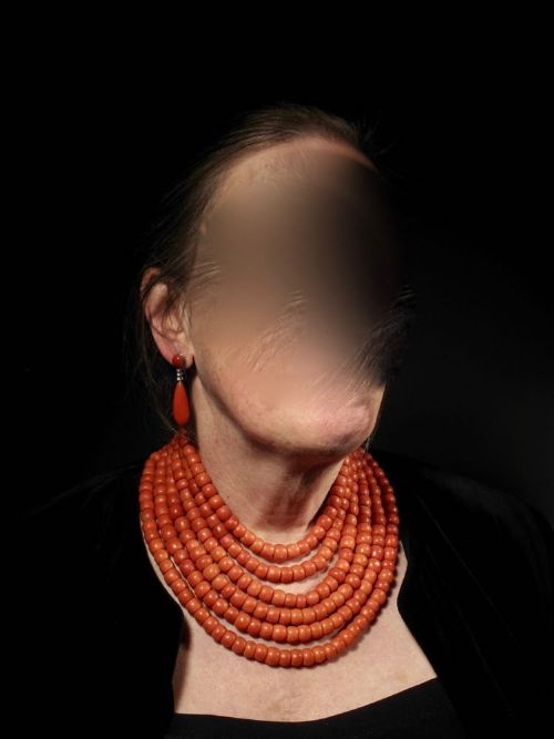 fig 1. A six-strand natural red coral bead necklace featuring intricate gold filigree clasps decorated with beaded granulation at each end.