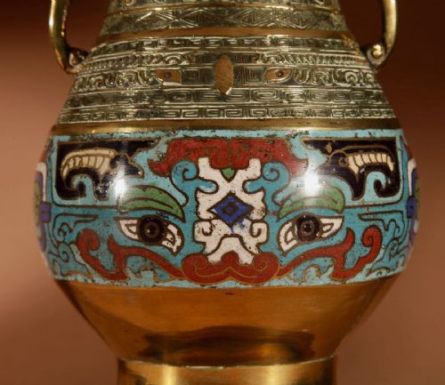 fig 1. A pair of Japanese brass vase-form table lamps decorated with polychrome champleve enamel and topped with pleated cream fabric shades.