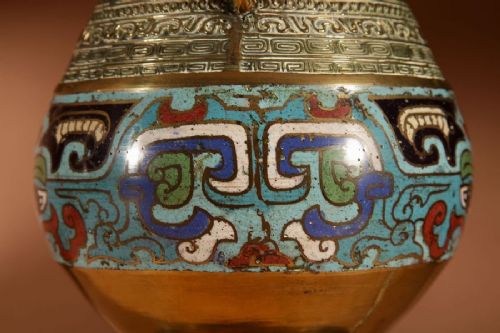 A pair of Japanese brass vase-form table lamps decorated with polychrome champleve enamel and topped with pleated cream fabric shades. View V