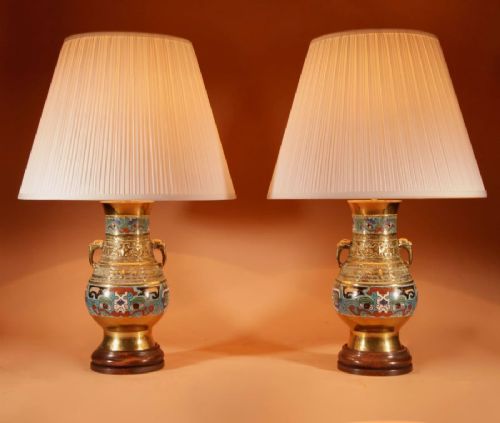 A pair of Japanese brass vase-form table lamps decorated with polychrome champleve enamel and topped with pleated cream fabric shades. View VI