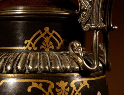 A 19th-century Grand Tour table lamp featuring a black ceramic urn base with red-figure chariot artwork, gilt bronze handles, and a pleated conical fabric shade. View VI