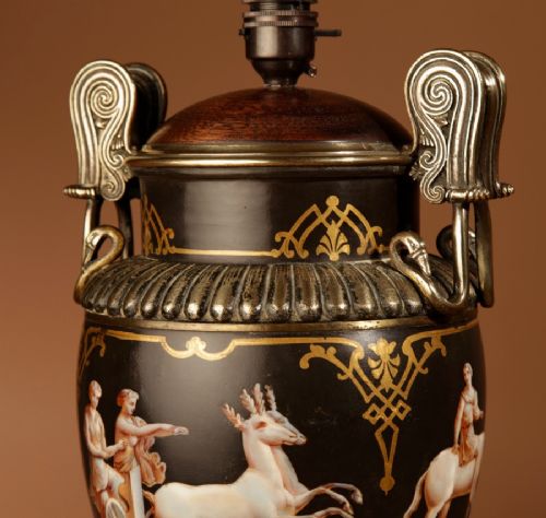 A 19th-century Grand Tour table lamp featuring a black ceramic urn base with red-figure chariot artwork, gilt bronze handles, and a pleated conical fabric shade. View IX