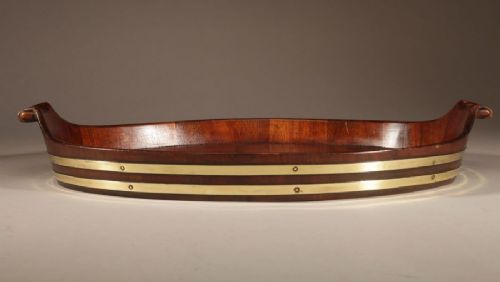 An oval mahogany serving tray featuring staved wood construction, twin carved side handles, and two horizontal brass bands securing the outer rim. View VII