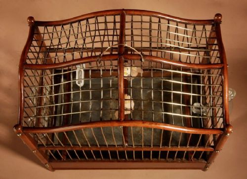 An Anglo-Dutch mahogany and brass birdcage featuring an arched wire dome roof, slide-out drawer tray, wooden perches, and accompanying glass vessels. View VIII