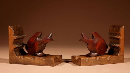 A pair of carved brown wooden bookends depicting goldfish figures mounted on angular wooden bases. View III