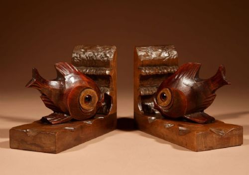A pair of carved brown wooden bookends depicting goldfish figures mounted on angular wooden bases. View VI